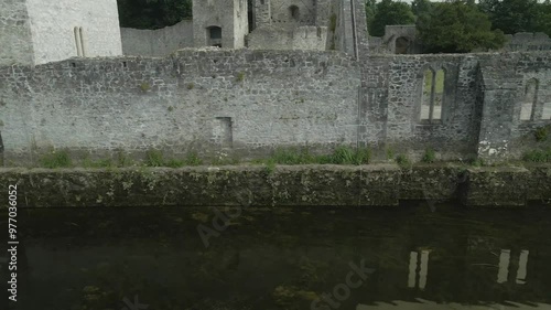 Historic Adare Castle ruins by the river Maigue in County Limerick, Ireland on a cloudy day photo