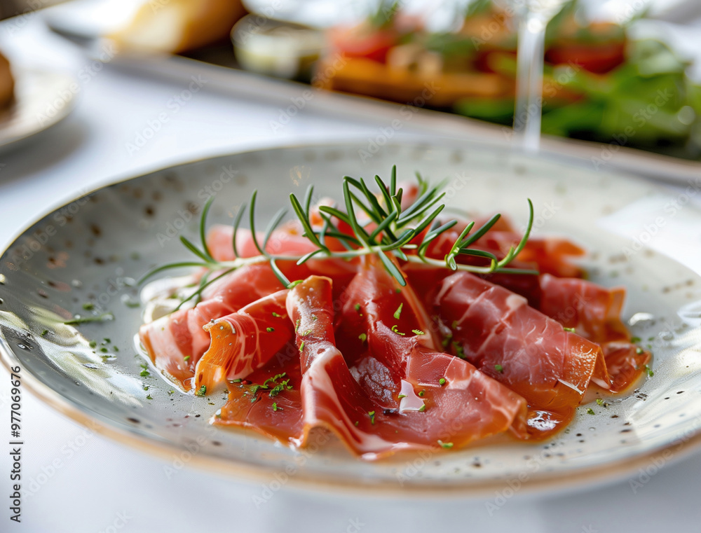 Artisan flatlay of Jamon Iberico with fresh herbs and gourmet spices Artisan flatlay of Jamon Iberico with fresh herbs and gourmet spices