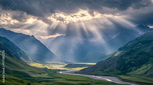 A stunning view of the mountains, a winding river, and a cloudy sky with a bright sunbeam. This is Truso Valley in Kazbegi, Georgia, a beautiful place to travel. photo