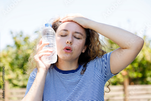 Tableau sur toile Young woman having hot flash and sweating in a warm summer day