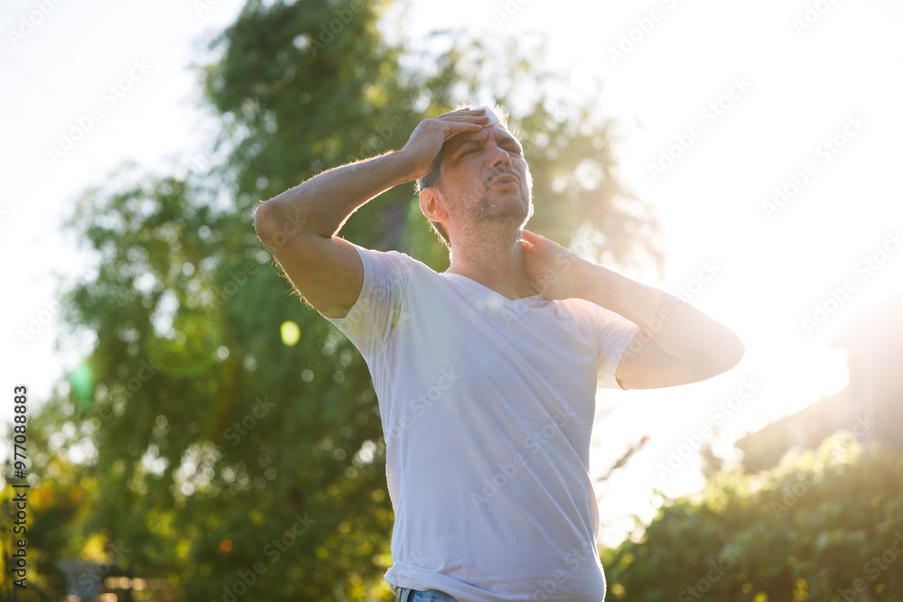 Young man having hot flash and sweating in a warm summer day Young man having hot flash and sweating in a warm summer day