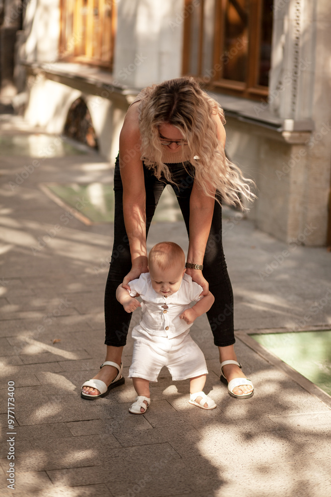 A mother with a 9-month-old babyis walking around the city A mother with a 9-month-old babyis walking around the city