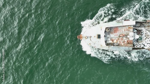 Aerial view of trawler vessel. Fishing boat trauler with sacks full of rapani photo