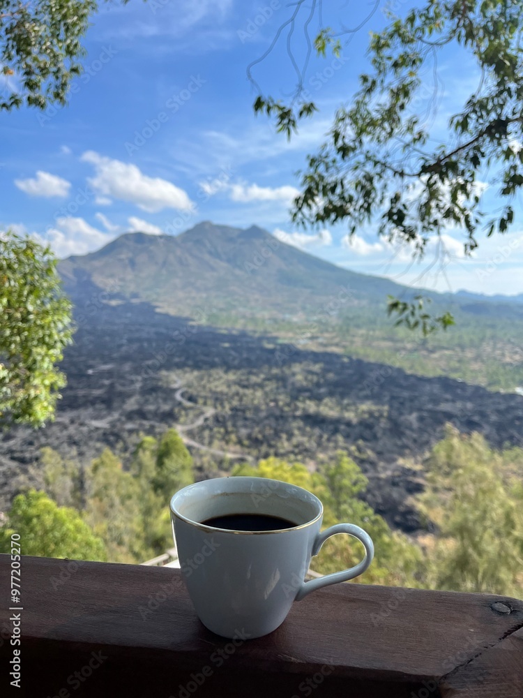cup of coffe on the mountain with view batur mountain and black lava, bali cup of coffe on the mountain with view batur mountain and black lava, bali