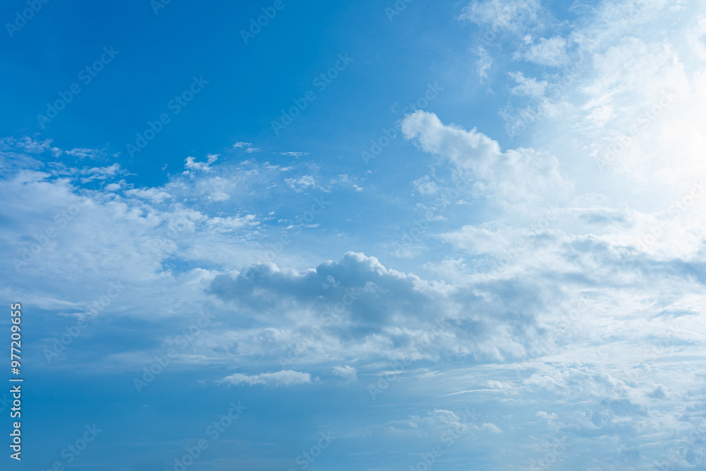 Beautiful fluffy white clouds drift across a clear blue sky, creating a breathtaking summer cloudscape Beautiful fluffy white clouds drift across a clear blue sky, creating a breathtaking summer cloudscape