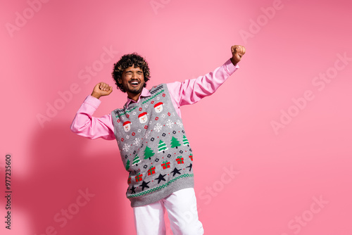 Photo of funky cool guy dressed ornament vest having fun enjoying x-mas day emtpy space isolated pink color background photo