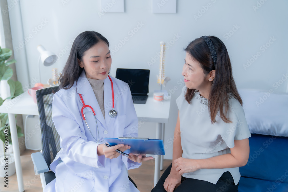 Fototapeta premium A doctor is giving advice to a patient who is coming for treatment about she's illness.