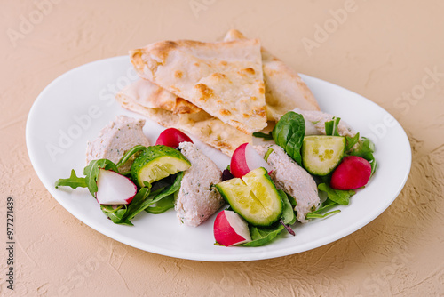 Delicious chicken pate served with pita bread and fresh vegetables on white plate