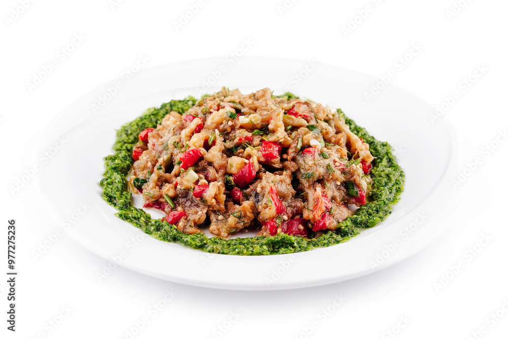 Delicious eggplant salad with green pesto decorating a white plate Delicious eggplant salad with green pesto decorating a white plate
