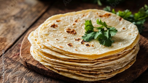 Stack of homemade corn tortillas resting on rustic wooden table photo