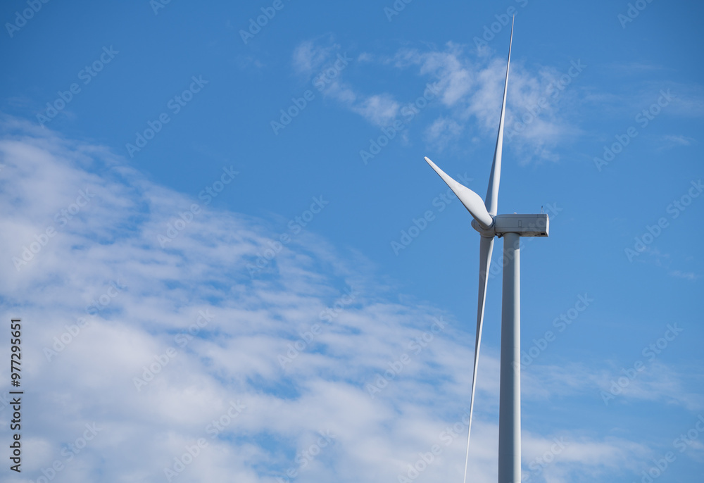 Wind turbines against blue sky, Wind energy. Wind power. Sustainable, renewable energy. Wind turbine generate electricity. Sustainable resources. Green technology for energy sustainability. Wind turbines against blue sky, Wind energy. Wind power. Sustainable, renewable energy. Wind turbine generate electricity. Sustainable resources. Green technology for energy sustainability.