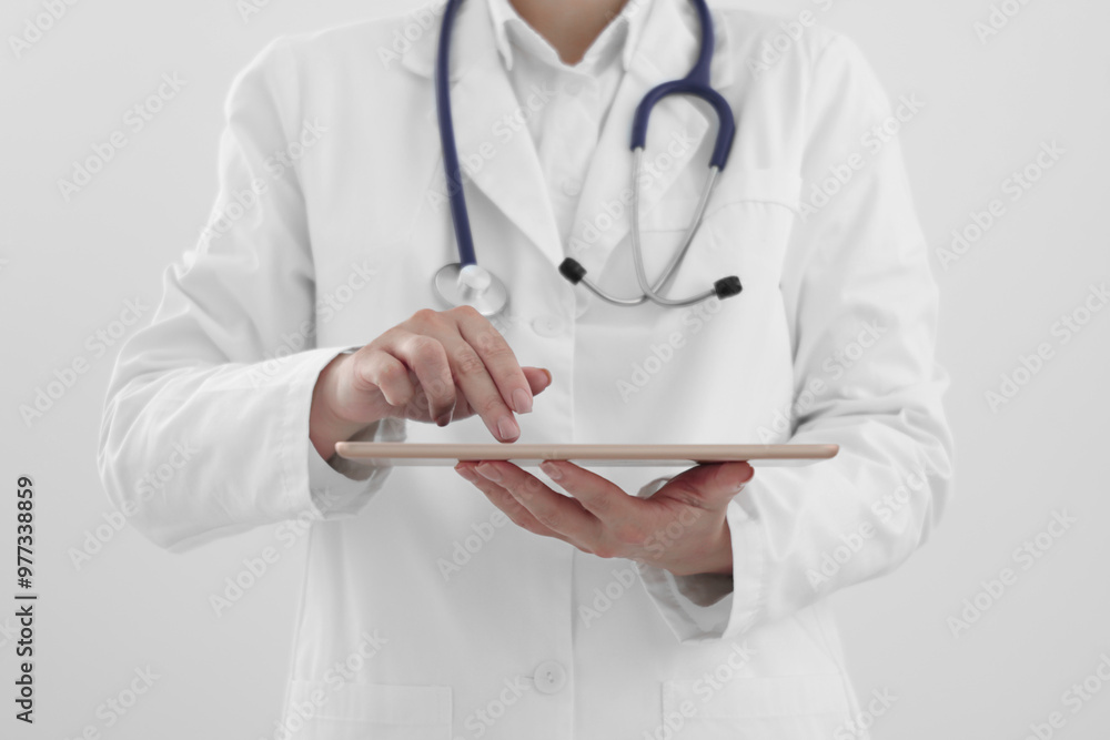 Doctor with tablet on white background, closeup view