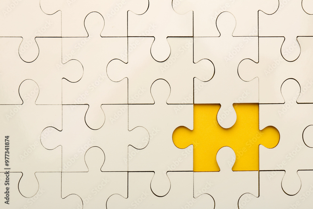 White puzzle with missing piece on yellow background, top view White puzzle with missing piece on yellow background, top view