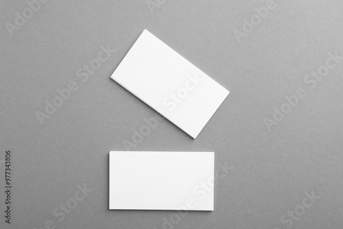 Blank business cards on grey background, top view. Mockup for design