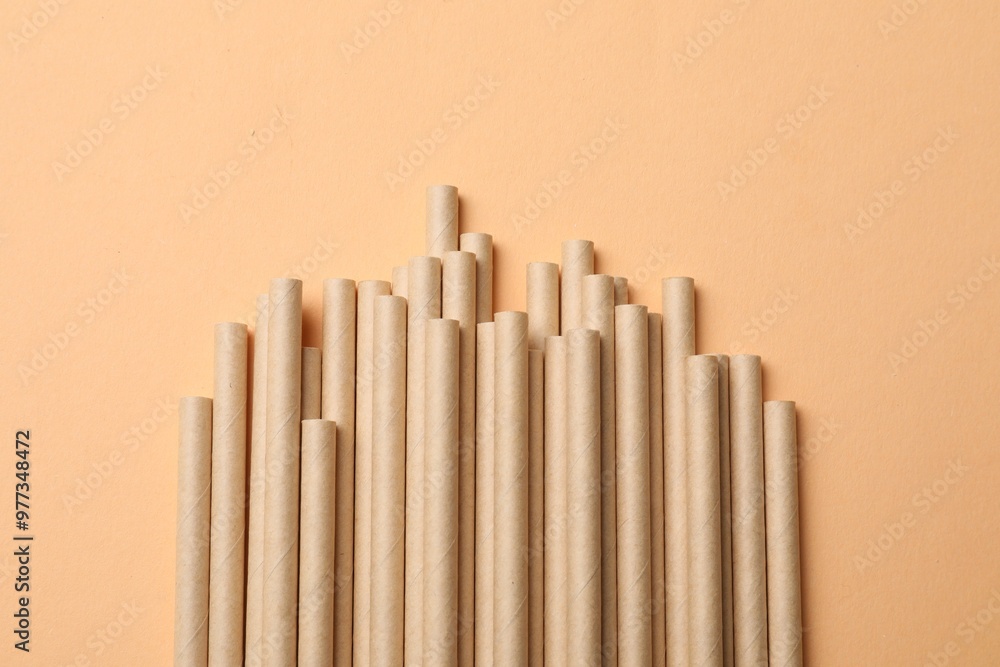 Obraz premium Bamboo drinking straws on beige background, top view