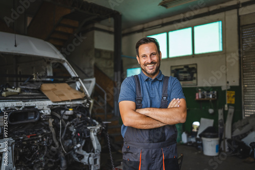 Car mechanic smile confidently with car in background at shop