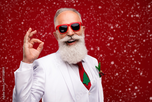 Photo of happy charming positive man make okay sign recommend wear sunglass isolated on red color background