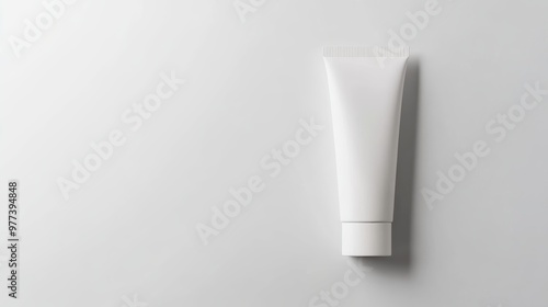 Elegant cosmetic tube mockup, minimalist design, clean white surface, soft magazine-inspired shadows