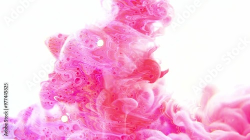 Pink ink dropped in water on white background  photo