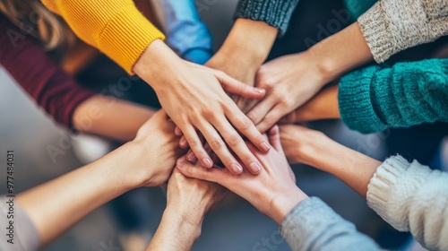 A group of diverse hands coming together in unity, symbolizing teamwork, collaboration, and shared goals in a creative setting.