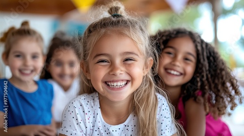 A group of smiling children share a joyful moment together, conveying a sense of unity and friendship. The colorful background adds a lively, fun atmosphere.