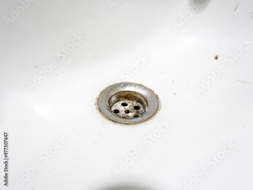 A dirty, messy sink. An old, dirty washbasin that is a breeding ground for germs and bacteria. Bathroom cleaning, housework. Example images of germ sources in bathrooms and kitchens. photo