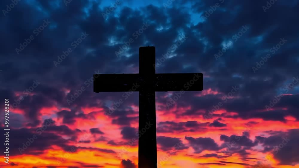 A silhouette of a cross against a vibrant sunset sky with colorful clouds. A silhouette of a cross against a vibrant sunset sky with colorful clouds.