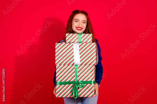 Photo of adorable lovely girl wear ugly ornament sweater celebrating noel preparing xmas gifts empty space isolated red color background