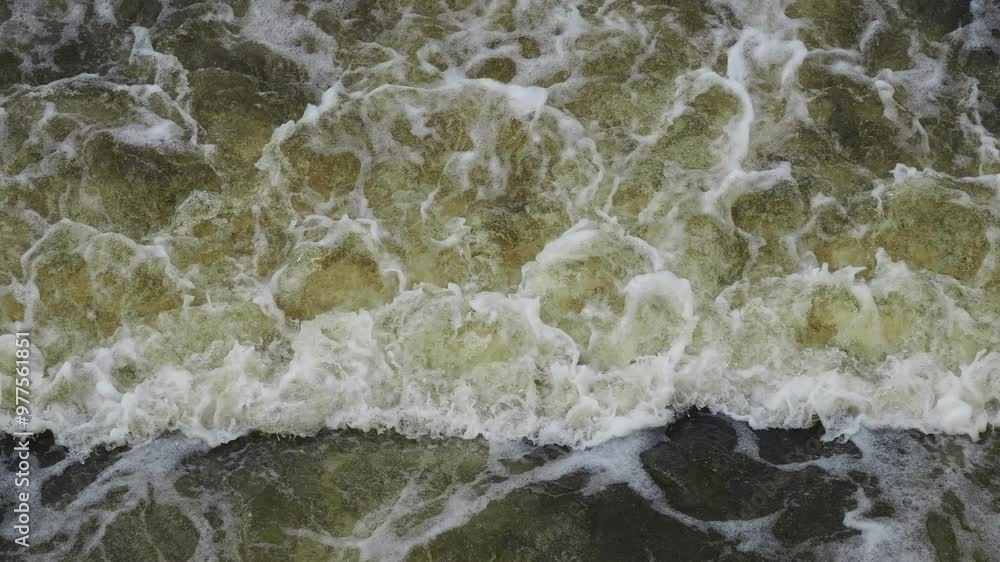 Water in the river overflowing through a weir. Water in the river overflowing through a weir.