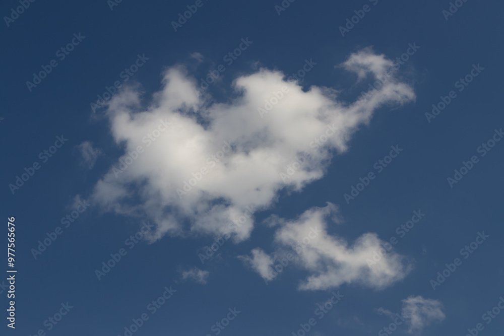 A beautiful, fluffy cloud drifting across a clear blue sky, showcasing nature's serene beauty and vastness. A beautiful, fluffy cloud drifting across a clear blue sky, showcasing nature's serene beauty and vastness.