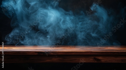 Empty wooden table with smoke on dark background.