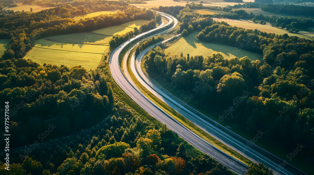 Fototapeta premium The view from above a rural overpass, with a winding road stretching through farmland