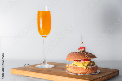 Close-up of burger and french fries on table against white background