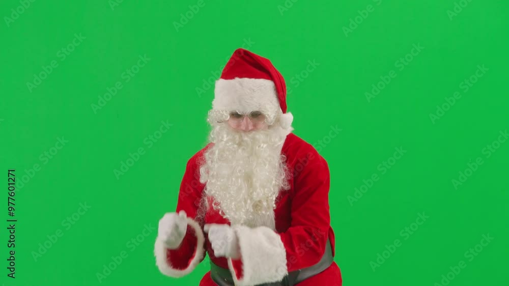Portrait of man dressed as Santa on chroma key green screen background. Santa Claus in red suit dancing funny. Portrait of man dressed as Santa on chroma key green screen background. Santa Claus in red suit dancing funny.