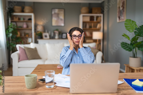 Young businesswoman small company owner, frustrated about statistics. Worried business female, freelancer, finance and economy expert, having issue and nervous while she work from home office.