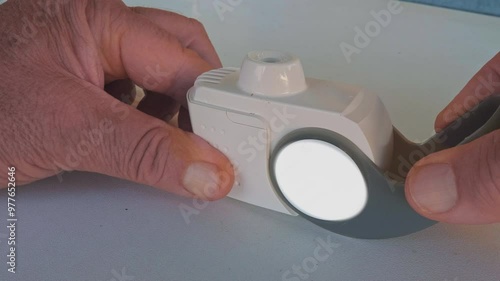 Patient opens the mouthpiece cover of the inhaler containing a medicine to relieve symptoms in adult patients with chronic obstructive pulmonary disease photo