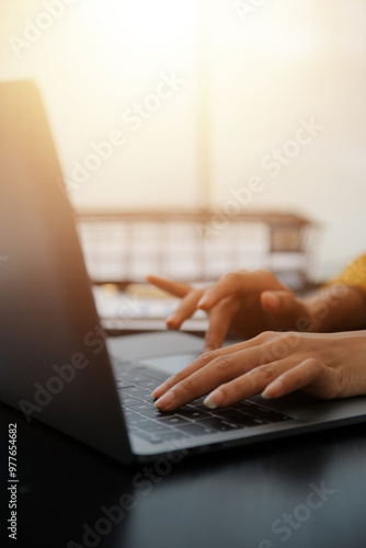 Close up Business woman using calculator and laptop for do math finance on wooden desk, tax, accounting, statistics and analytical research concept
