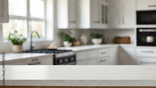 A clean modern kitchen table top with white cabinetry and appliances