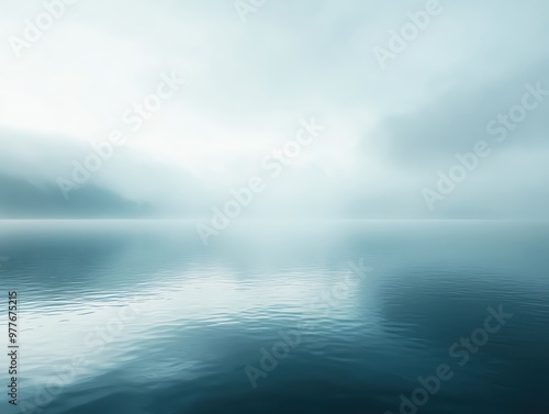 Misty lake with calm water and soft light.