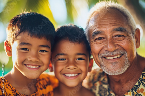 Grandfather and his grandsons are spending time together outside and smiling