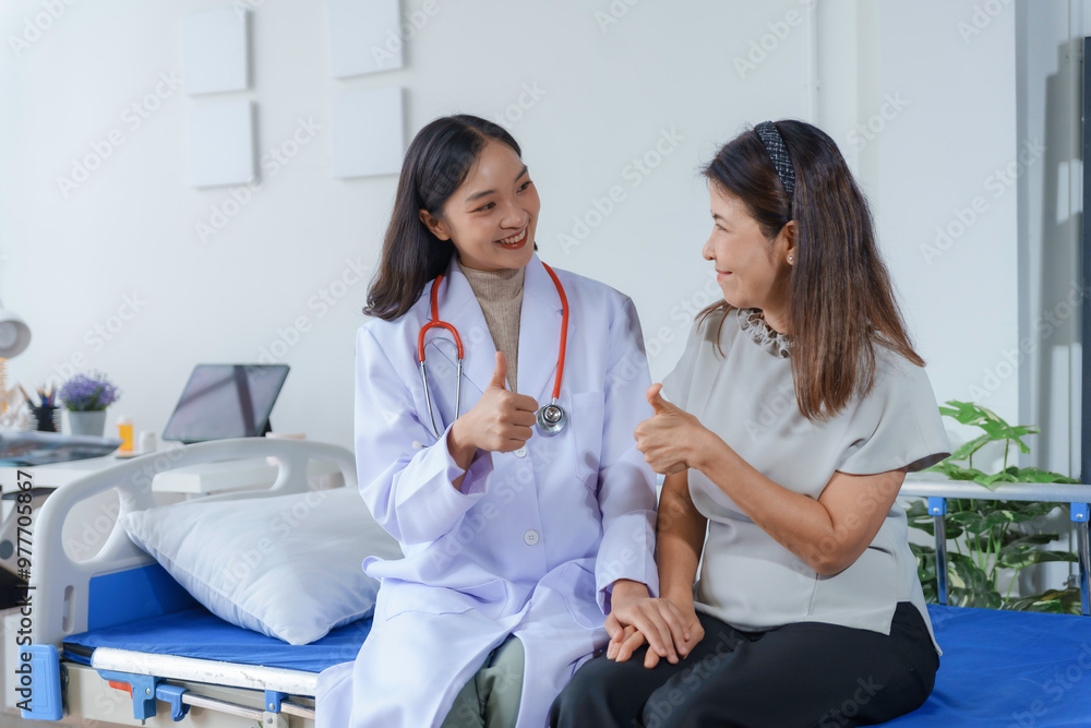 Cheerful doctor in a stethoscope gives a thumbs up to her smiling patient, who returns the gesture Cheerful doctor in a stethoscope gives a thumbs up to her smiling patient, who returns the gesture
