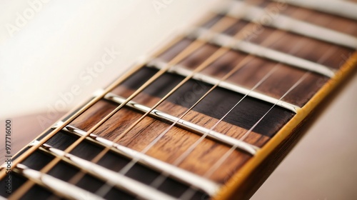 A detailed view of the strings and fretboard of an electric guitar, showcasing the craftsmanship against a pale backdrop