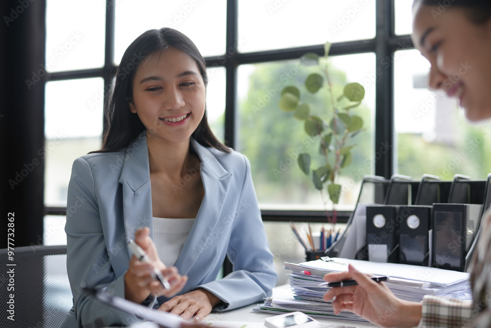 Two female entrepreneurs in a modern office, brainstorming and planning for success. Working together with assurance, they exchange ideas and collaborate effectively Two female entrepreneurs in a modern office, brainstorming and planning for success. Working together with assurance, they exchange ideas and collaborate effectively