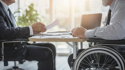 meeting between a worker and their boss regarding the worker's recent injury and disability compensation. Show the worker seated at a desk, possibly with medical documents or compe photo