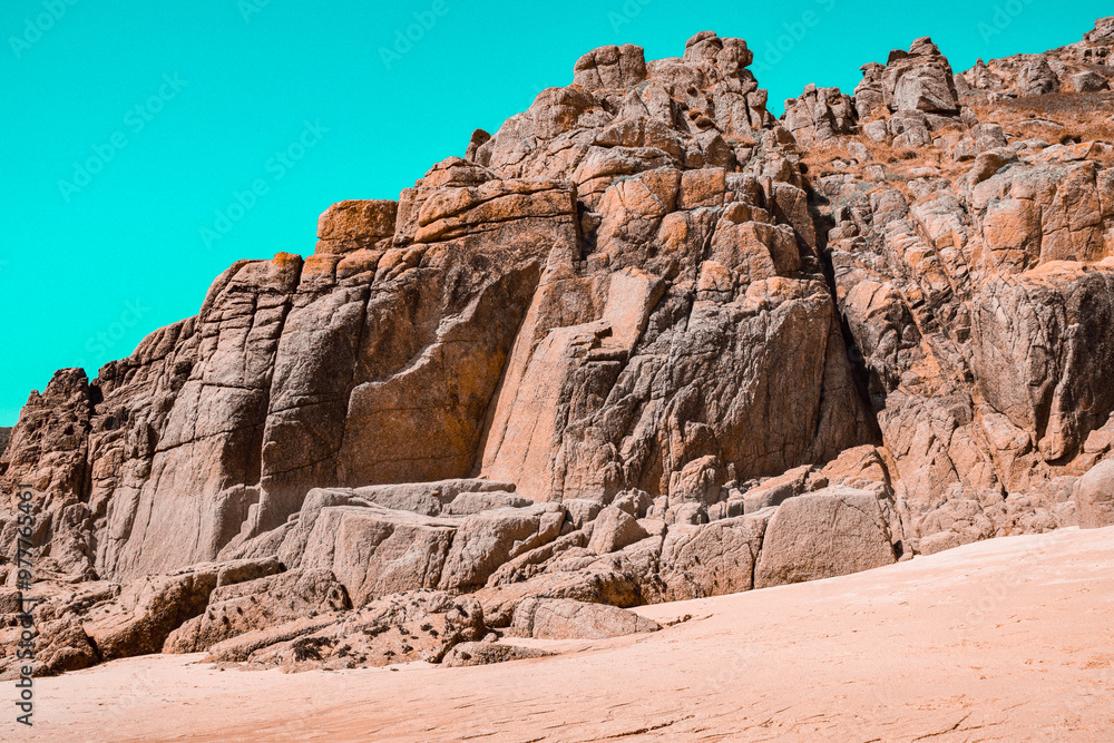 Red rocky formations by the beach in Cornwall Red rocky formations by the beach in Cornwall
