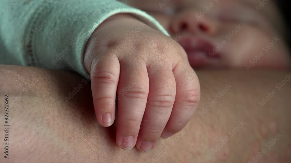 Baby sleeping peacefully with hand resting on mother’s arm in a close-up view, showing gentle touch and peaceful bonding moment between infant and mother Baby sleeping peacefully with hand resting on mother’s arm in a close-up view, showing gentle touch and peaceful bonding moment between infant and mother