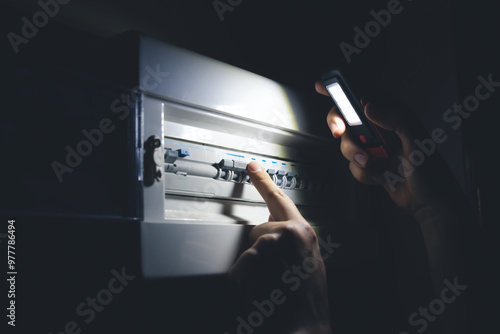 Canvas Print Electrical blackout. Man switching fuses