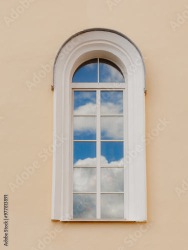 Images of clouds are reflected in the glass window of the building. Minimalism, inspiration and freedom of thought