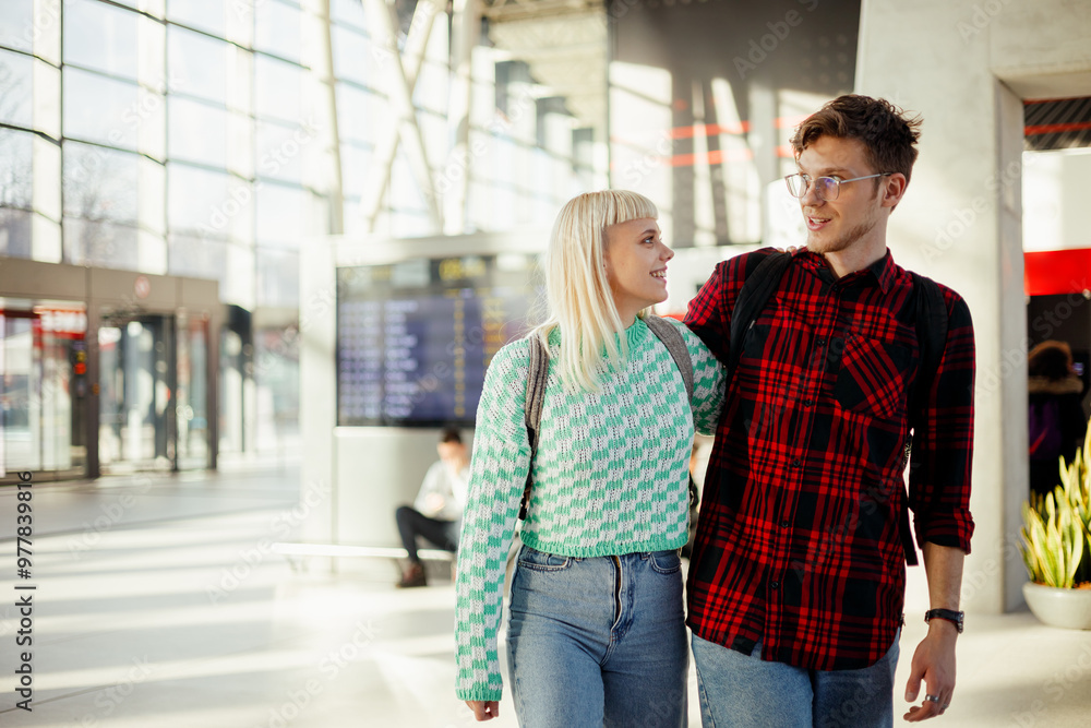 Happy traveler couple is hugging and walking at train station. Happy traveler couple is hugging and walking at train station.