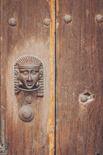 Decorative metal ring knock door, in Italy most homes have doors with these handles. European classical knocker of a old Wooden door